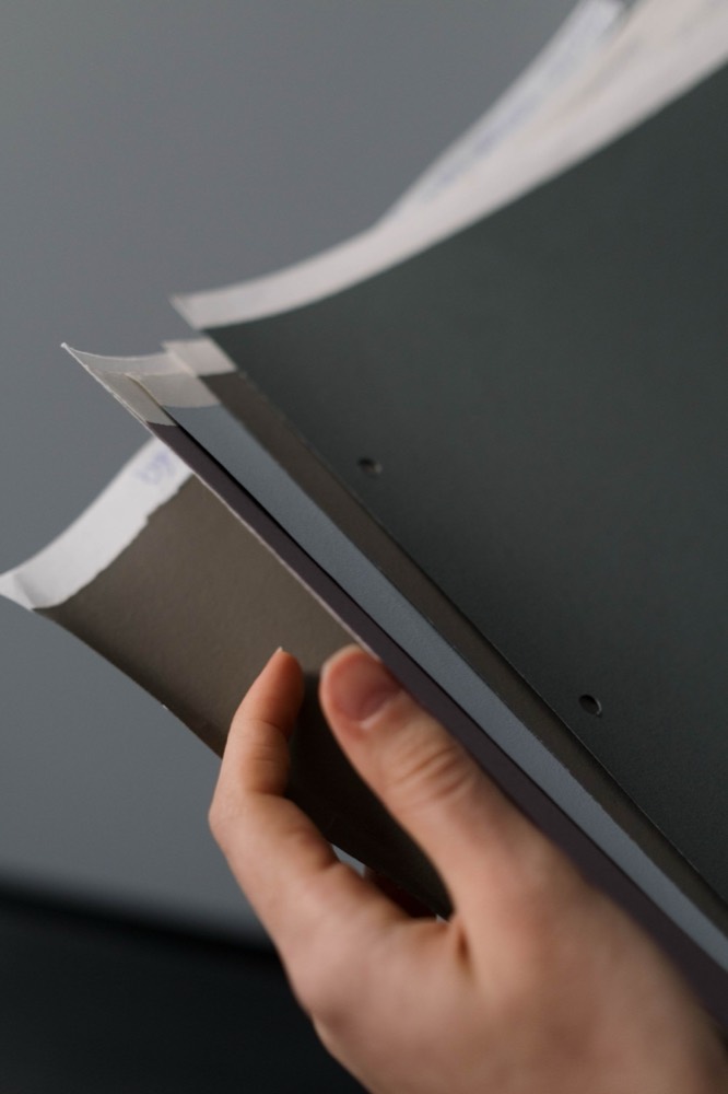 A hand holding thick cardstock samples