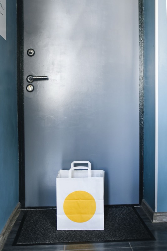 A takeout bag left at a front door